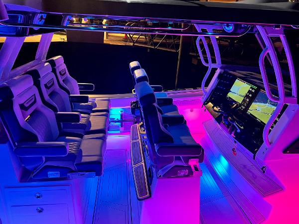 Slide: The Image of Interior of 2025 Blackfin 400 CC boat with illuminated seating and advanced navigation displays. - 16