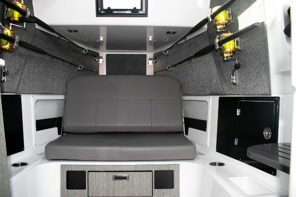 Slide: The Image of 2025 Blackfin 400 CC cabin interior with gray seating and fishing rod holders. - 19