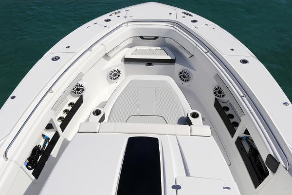 Slide: The Image of 2025 Blackfin 400 CC boat interior with seating and speakers on calm water. - 22
