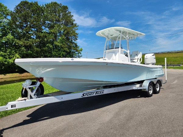 Slide: The Image of 2025 BlackJack 256 Coastal boat on trailer, parked outdoors under clear blue sky. - 1