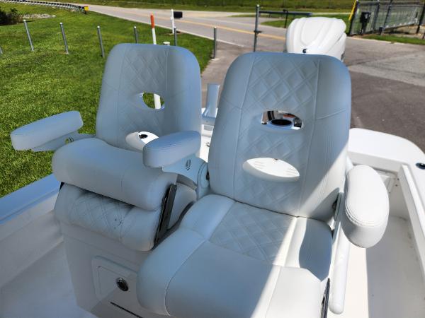 Slide: The Image of Luxurious white seating on 2025 BlackJack 256 Coastal boat, featuring quilted design and armrests. - 12