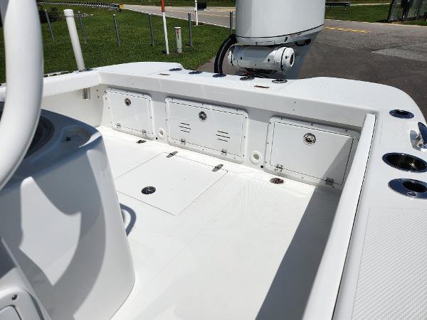 Slide: The Image of 2025 BlackJack 256 Coastal boat interior with storage compartments and fishing rod holders. - 18