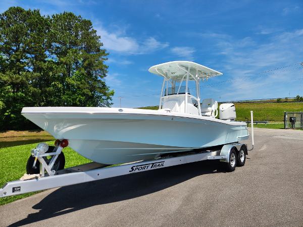 Slide: The Image of 2025 BlackJack 256 Coastal boat on trailer, parked outdoors under clear blue sky. - 19