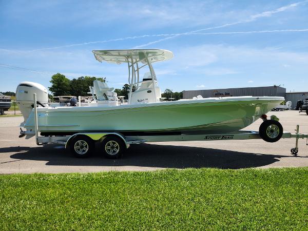 Slide: The Image of 2025 BlackJack 256 Coastal boat on trailer, parked outdoors under clear blue sky. - 6