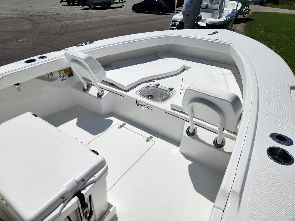 Slide: The Image of 2025 BlackJack 256 Coastal boat interior with white seating and storage compartments. - 8