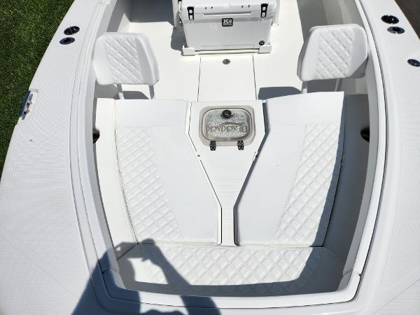 Slide: The Image of 2025 BlackJack 256 Coastal boat interior with white seating and storage compartment. - 9
