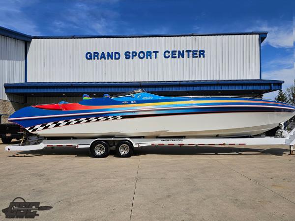 Slide: The Image of 2002 Black Thunder 460 SC boat on trailer at Grand Sport Center. - 2
