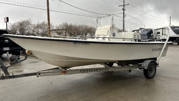Slide: The Image of 2000 Blazer 1860 boat on trailer, parked outdoors on a cloudy day. - 6