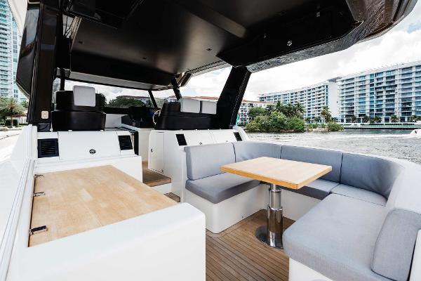 Slide: The Image of Interior of 2019 Bluegame BG62 yacht with modern seating and dining area. - 12