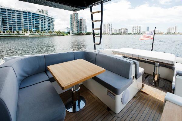 Slide: The Image of 2019 Bluegame BG62 yacht with modern seating area and waterfront city view. - 13