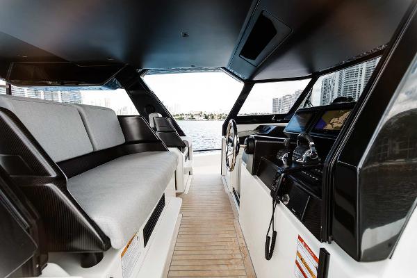 Slide: The Image of Interior of 2019 Bluegame BG62 yacht with modern helm and seating area. - 15