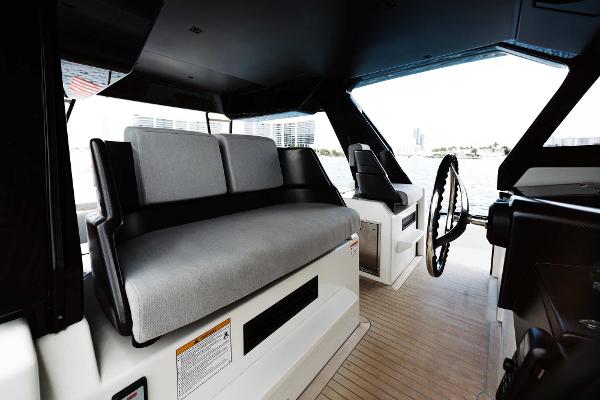 Slide: The Image of Interior helm station of 2019 Bluegame BG62 yacht with modern seating and steering wheel. - 16