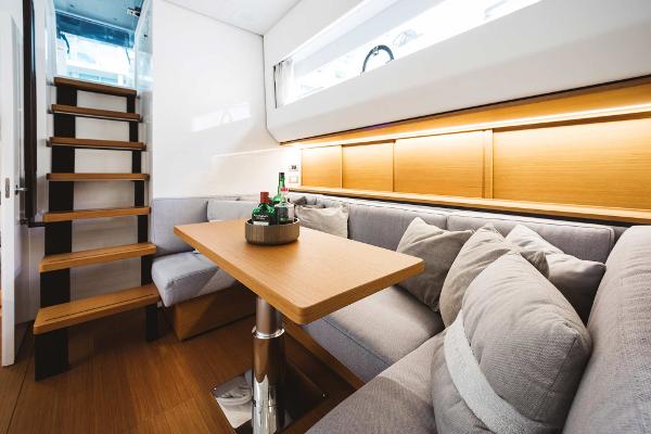 Slide: The Image of Interior of 2019 Bluegame BG62 yacht with cozy seating and wooden table. - 18
