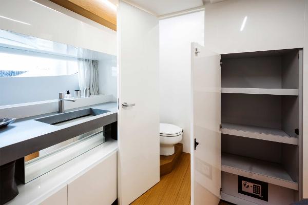 Slide: The Image of Modern bathroom in 2019 Bluegame BG62 yacht with sink, toilet, and storage cabinet. - 23