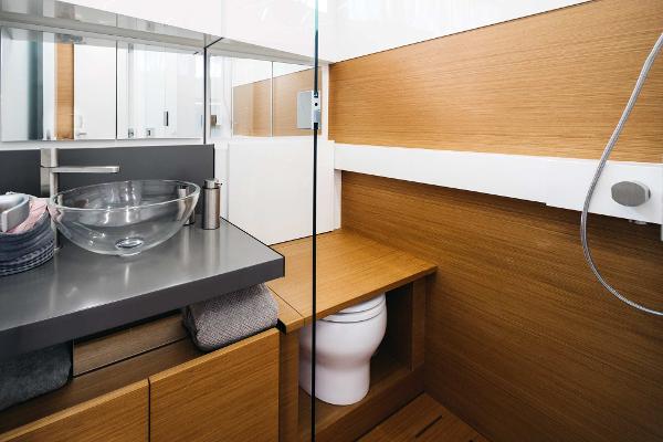 Slide: The Image of Modern bathroom on 2019 Bluegame BG62 yacht with glass sink and wooden accents. - 26