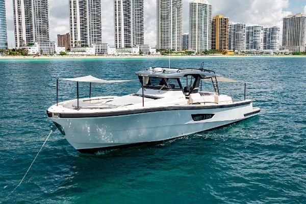 Slide: The Image of 2019 Bluegame BG62 yacht cruising near a city skyline. - 4