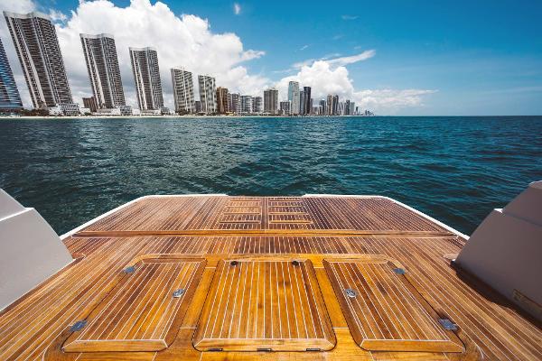 Slide: The Image of View from the deck of a 2019 Bluegame BG62 yacht overlooking a coastal city skyline. - 7