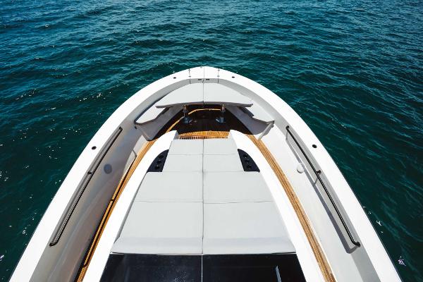 Slide: The Image of 2019 Bluegame BG62 yacht bow with sunbathing area on open water. - 8