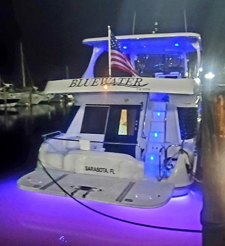 Slide: The Image of Bluewater 5800 yacht, 2000 model, docked at night with blue and purple lights, Sarasota, FL. - 19