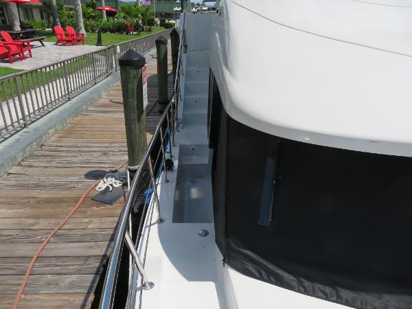 Slide: The Image of Side deck view of 2000 Bluewater 5800 yacht docked at marina. - 22