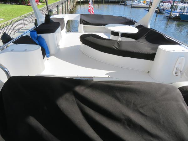 Slide: The Image of Upper deck of 2000 Bluewater 5800 yacht with covered seating and table. - 27