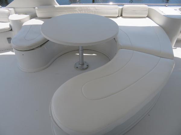 Slide: The Image of Luxurious seating area on a 2000 Bluewater 5800 yacht with a round table. - 28