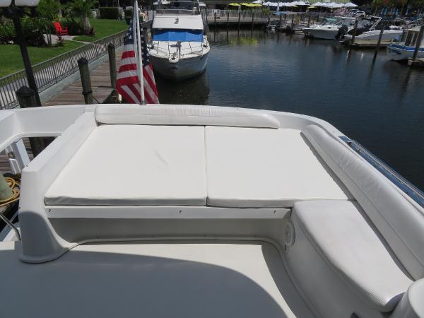 Slide: The Image of Bluewater 5800 yacht (2000) with sunbathing area, docked at marina. - 30