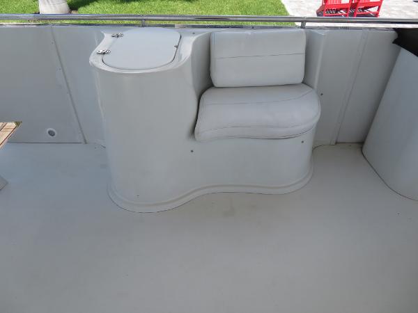 Slide: The Image of Bluewater 5800 (2000) boat interior with white seating and storage compartment. - 32