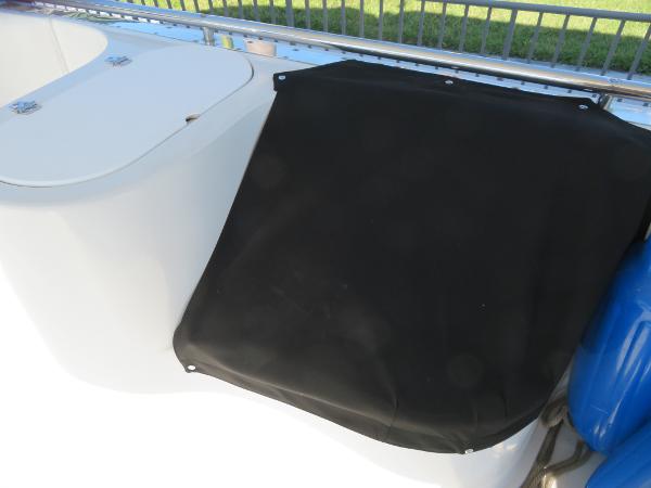 Slide: The Image of Bluewater 5800 boat deck with storage compartment and black cover, year 2000. - 33