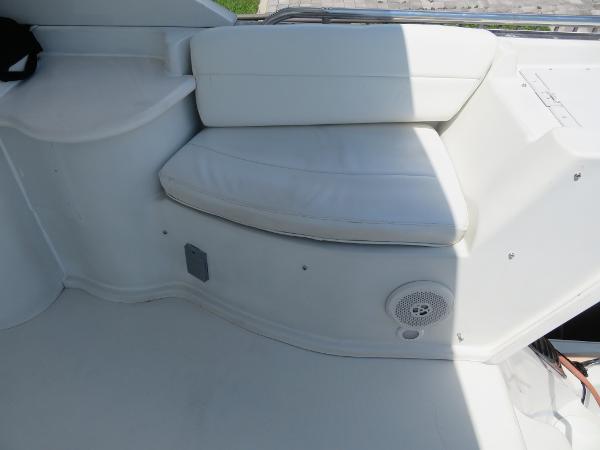 Slide: The Image of White seating area on a 2000 Bluewater 5800 boat with built-in speaker. - 34
