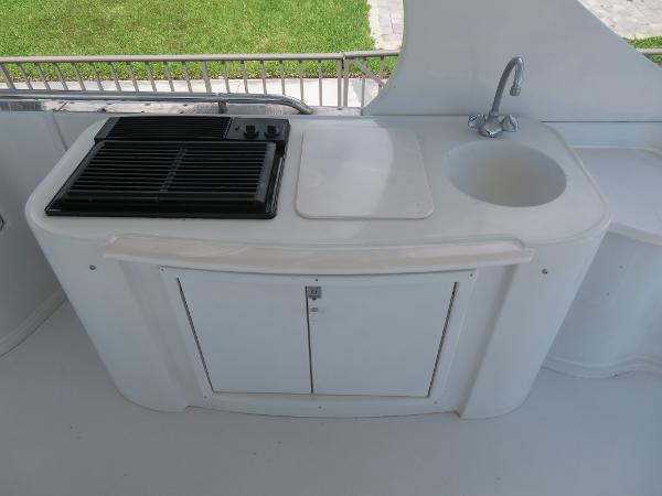 Slide: The Image of Outdoor kitchenette on a 2000 Bluewater 5800 yacht with grill and sink. - 36