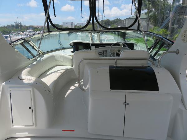 Slide: The Image of Interior view of a 2000 Bluewater 5800 yacht with white seating and control panel. - 38