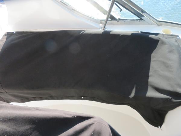 Slide: The Image of Covered seating area on a 2000 Bluewater 5800 boat. - 43