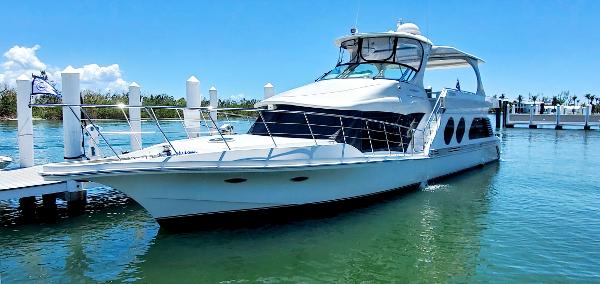 Slide: The Image of Luxury 2000 Bluewater 5800 yacht docked at marina on sunny day. - 9