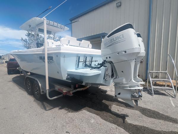 Slide: The Image of 2024 Bluewater Sportfishing 2850 boat with Suzuki outboard motor on trailer. - 1