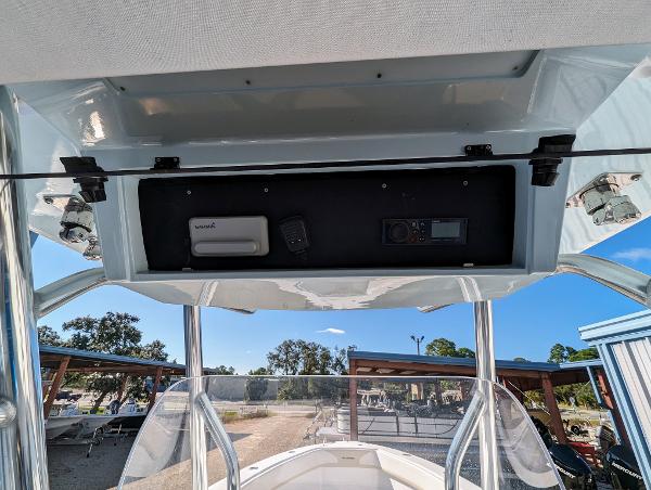 Slide: The Image of 2024 Bluewater Sportfishing 2850 boat console with electronics and storage compartment. - 11
