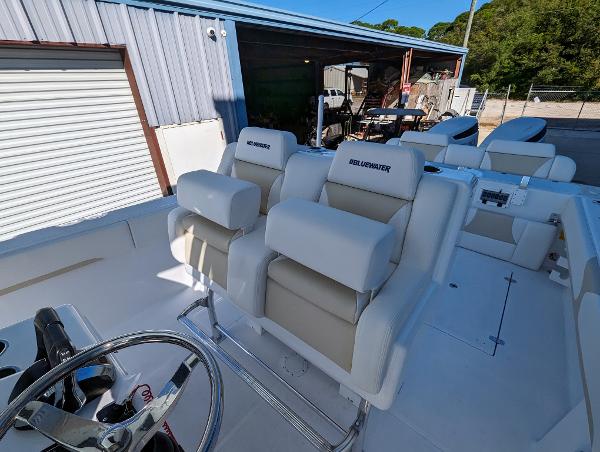 Slide: The Image of 2024 Bluewater Sportfishing 2850 boat with dual captain's chairs and steering wheel. - 19