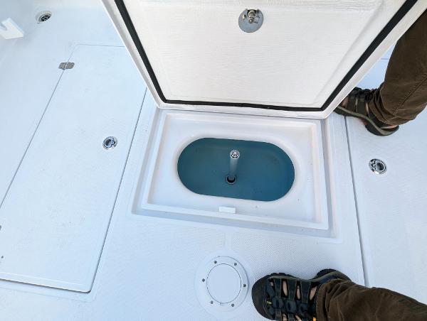 Slide: The Image of 2024 Bluewater Sportfishing 2850 boat deck with open storage compartment. - 20