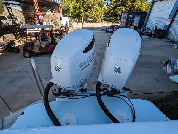 Slide: The Image of Twin Suzuki outboard motors on a 2024 Bluewater Sportfishing 2850 boat. - 21