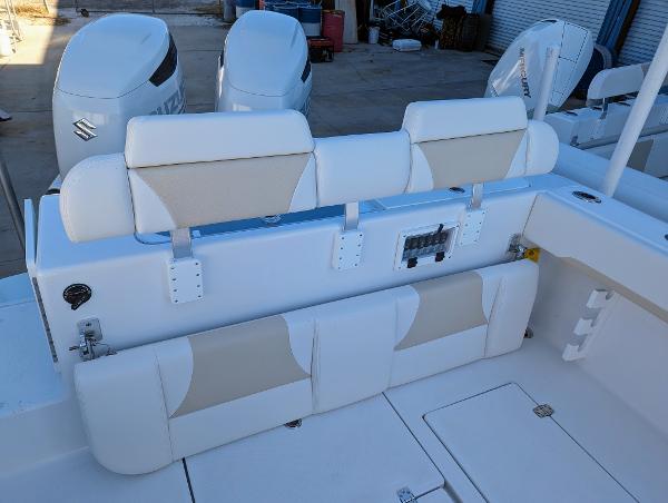 Slide: The Image of 2024 Bluewater Sportfishing 2850 boat with dual outboard engines and cushioned seating. - 4
