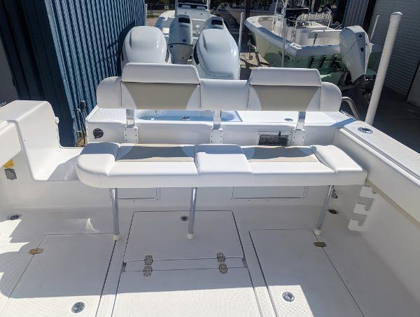 Slide: The Image of 2024 Bluewater Sportfishing 2850 boat with dual engines and spacious seating area. - 5
