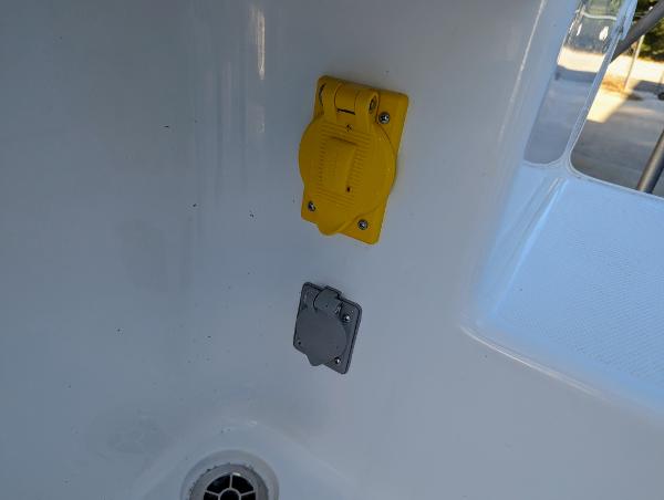 Slide: The Image of Close-up of electrical outlets on a 2024 Bluewater Sportfishing 2850 boat. - 6