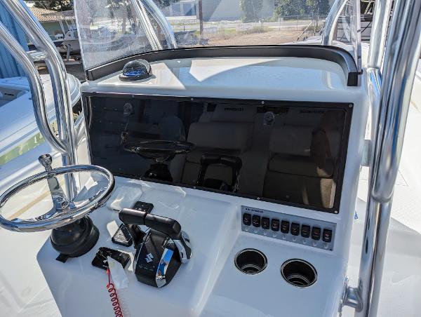 Slide: The Image of 2024 Bluewater Sportfishing 2850 boat console with steering wheel and control panel. - 8