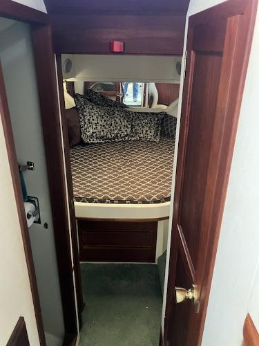 Slide: The Image of 1989 Bluewater Yachts 55' Coastal Cruiser bedroom with patterned bedding. - 10