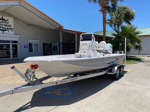 Slide: The Image of 2023 Blue Wave 2200 STL boat on a trailer outside Gulf Coast Marine. - 1