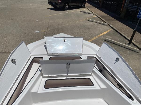 Slide: The Image of 2023 Blue Wave 2200 STL boat with open storage compartments. - 10