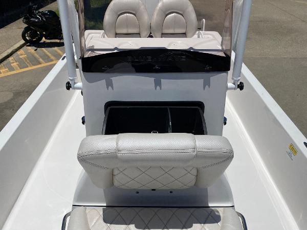 Slide: The Image of 2023 Blue Wave 2200 STL boat interior with white seating and storage compartment. - 12