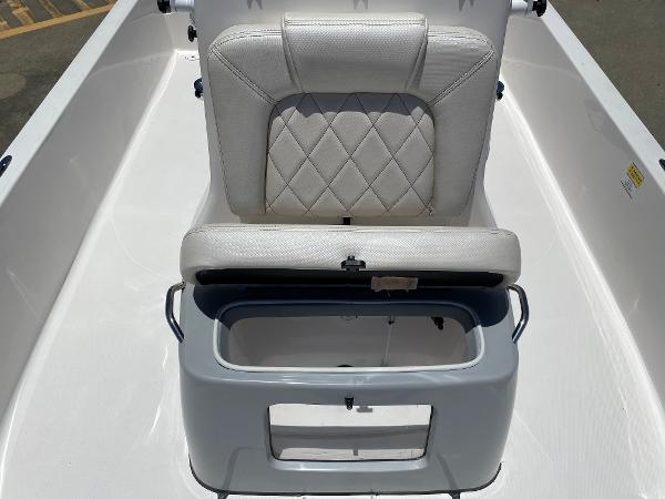 Slide: The Image of 2023 Blue Wave 2200 STL boat with white cushioned seat and storage compartment. - 13