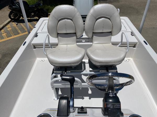 Slide: The Image of 2023 Blue Wave 2200 STL boat with dual captain's chairs and steering console. - 16