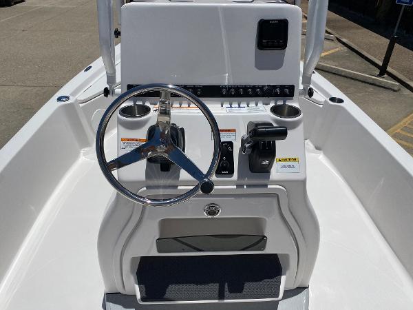 Slide: The Image of 2023 Blue Wave 2200 STL boat console with steering wheel and controls. - 18